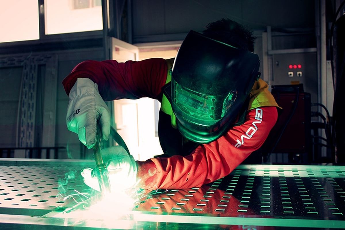 A welder working in full protective equipment