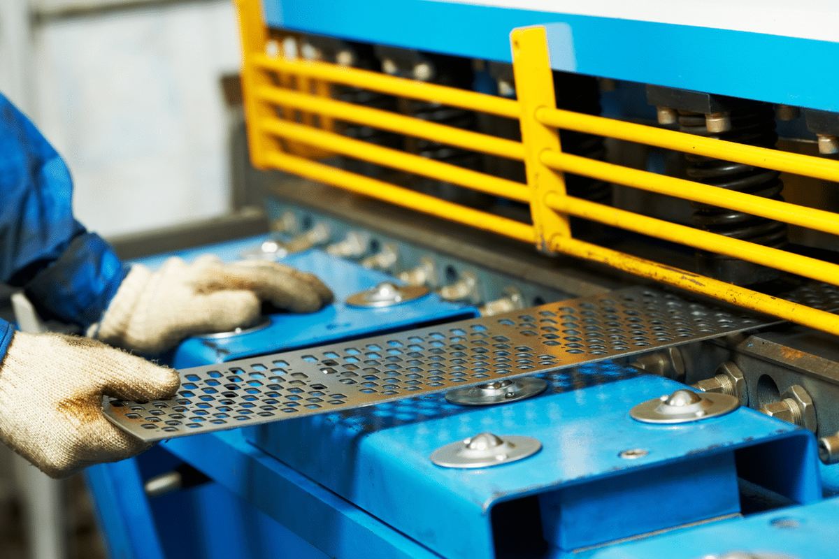 A part being loaded into a press