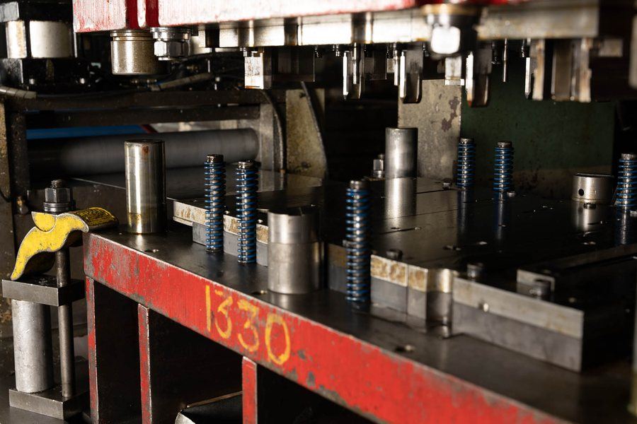 A progressive die with the carrier strip running through it