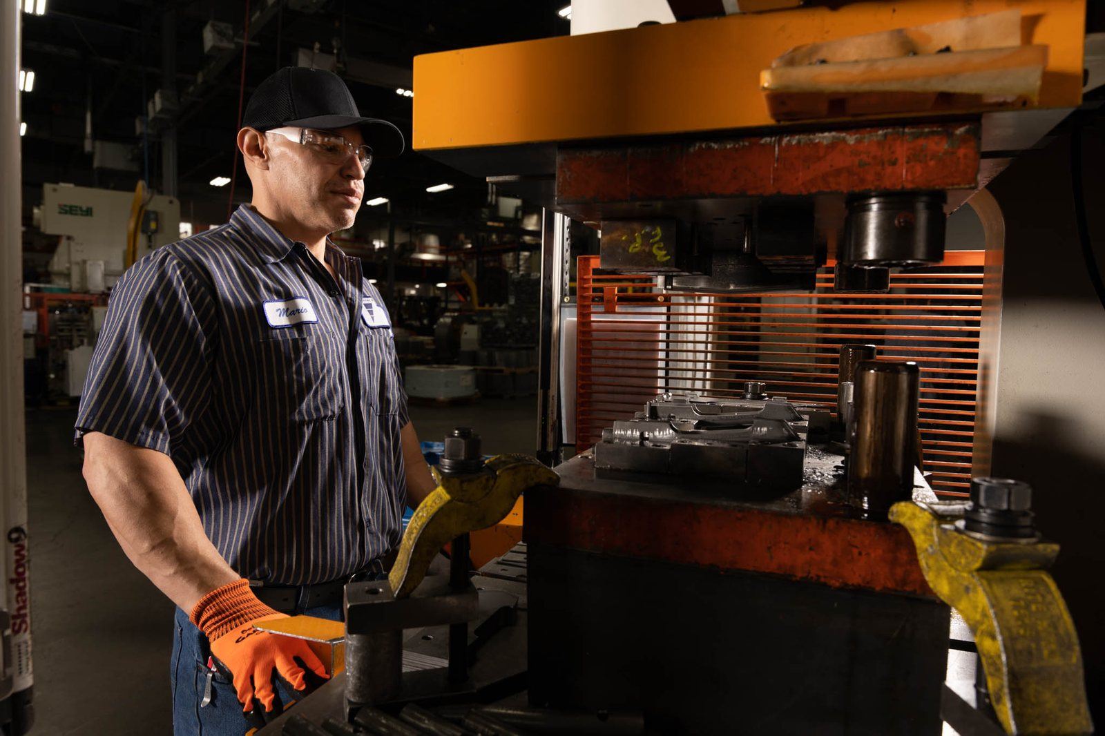 An operator at a press during a production run