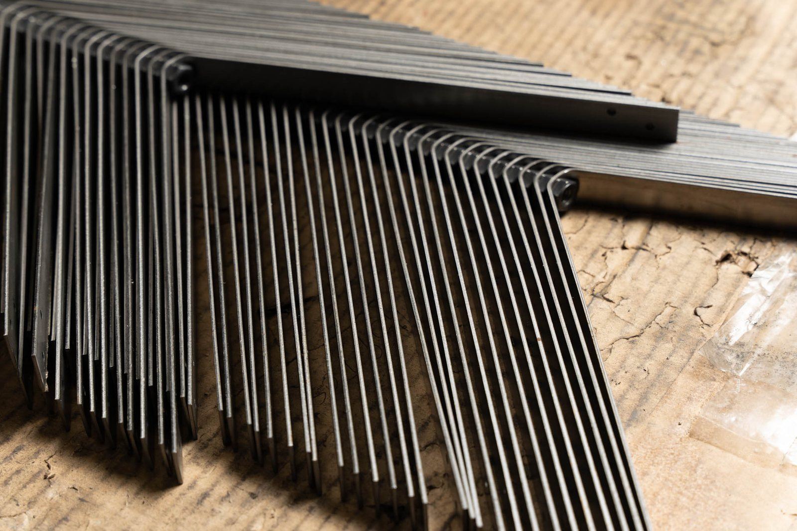 Long formed parts stacked on the bench